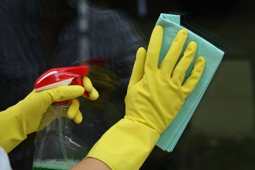 Cleaner working in a Brent home living room during a regular cleaning visit